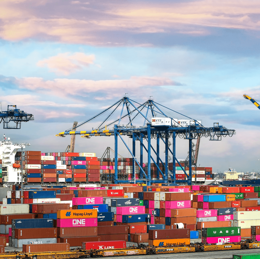 Shipping containers and cranes at a port.